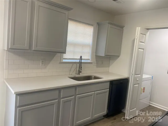 a kitchen with a sink and cabinets