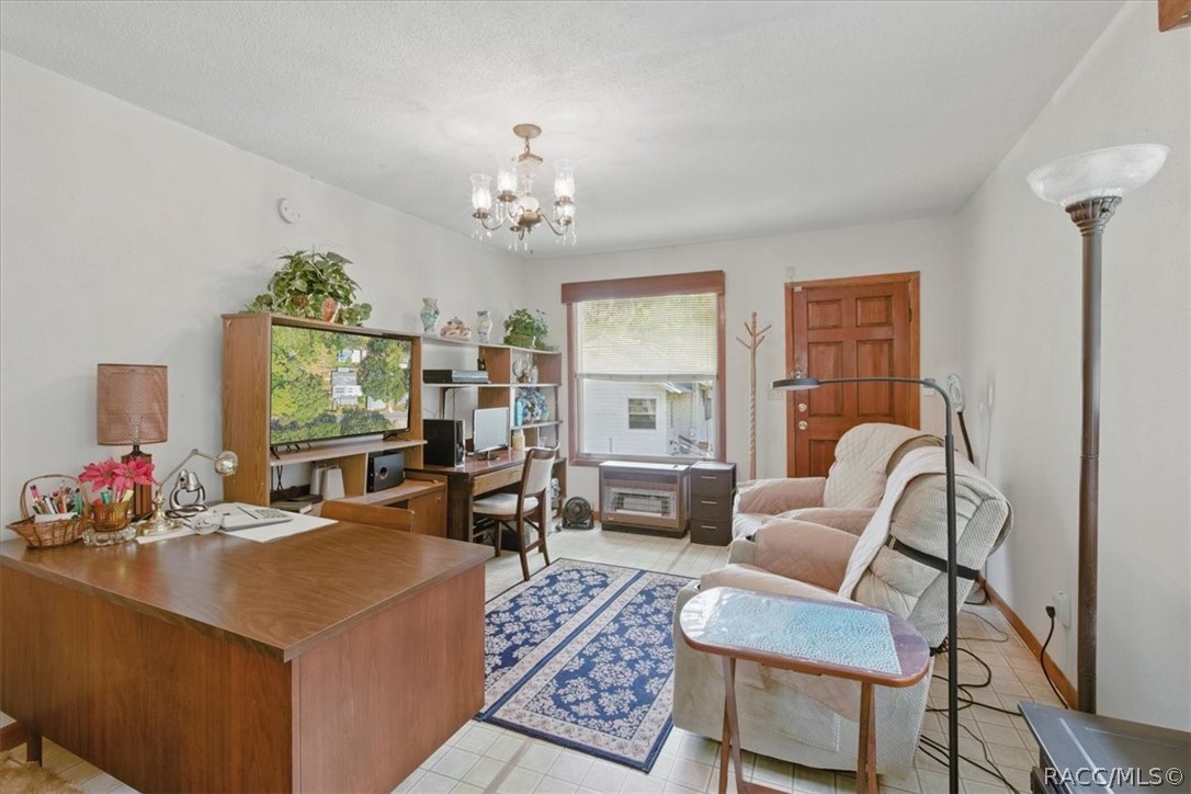 6 62nd Street Yankeetown, FL 34498 - Photo 15 of 55 a living room with furniture a chandelier and a window