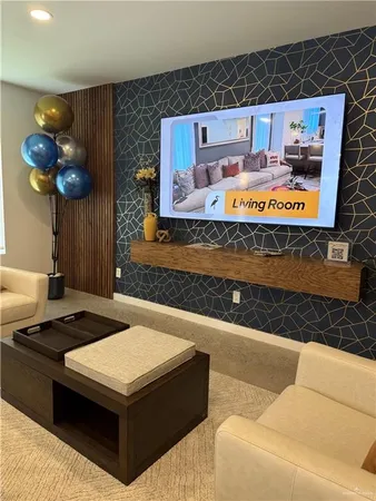 a living room with a table chairs and a refrigerator