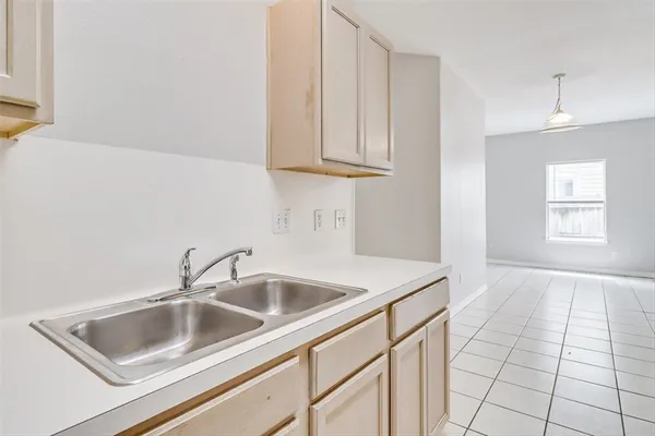 a kitchen with a sink cabinets and a window