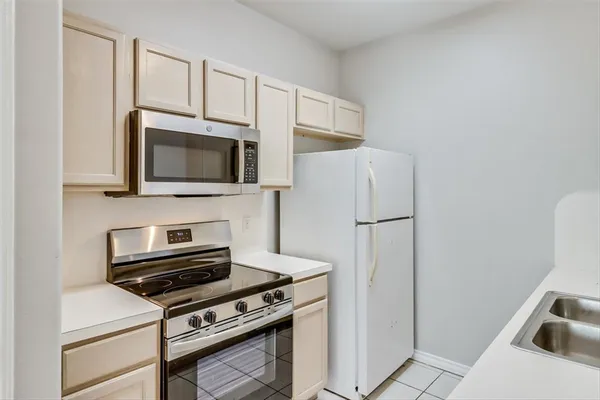 a kitchen with a refrigerator stove and microwave