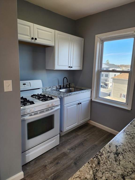 146 Middlesex Street, Unit 3 Fall River, MA 02723 - Photo 1 of 9 a kitchen with a stove and a sink