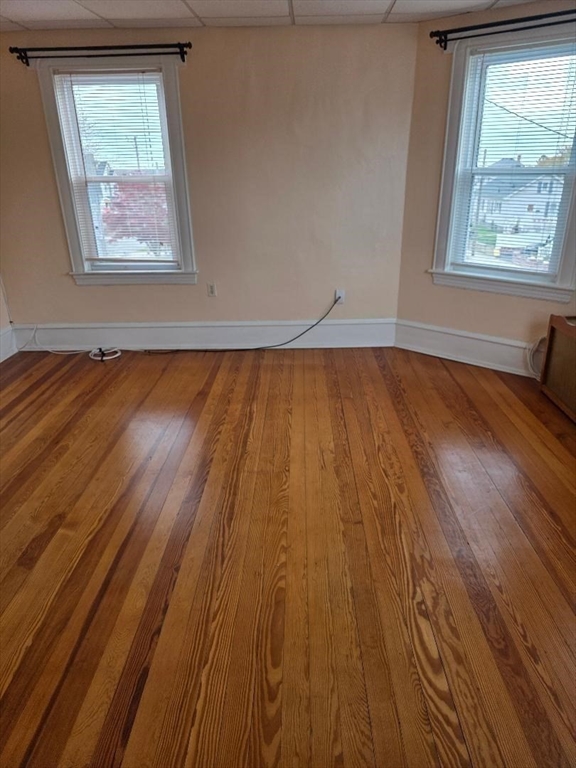 146 Middlesex Street, Unit 2 Fall River, MA 02723 - Photo 11 of 19 an empty room with wooden floor and windows