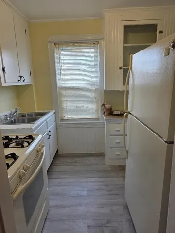 a kitchen with stainless steel appliances a stove a refrigerator and cabinets