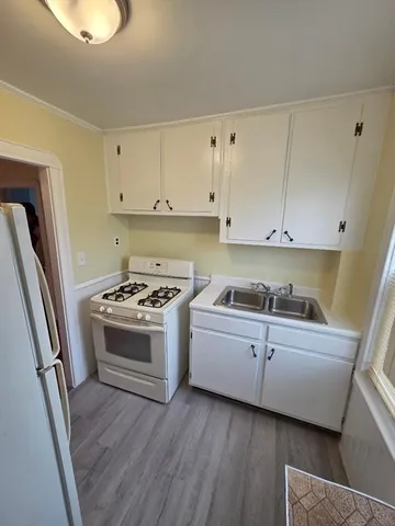 a view of a kitchen with stove and cabinets