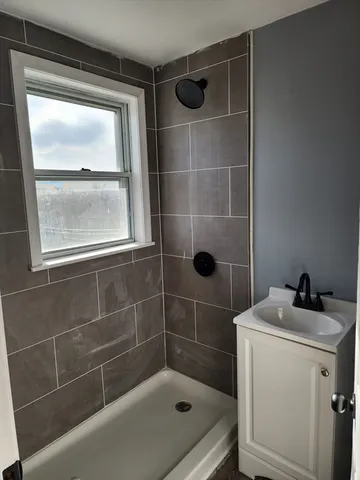 a bathroom with a shower a toilet and a sink
