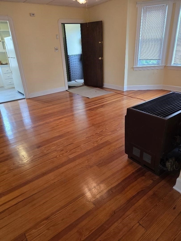 146 Middlesex Street, Unit 2 Fall River, MA 02723 - Photo 10 of 19 a view of an empty room with wooden floor and a window
