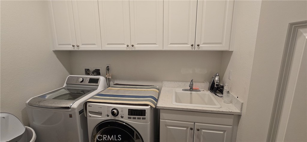 8221 Muir Lane Riverside, CA 92507 - Photo 19 of 31 Lot of cabinets in laundry room and utility sink