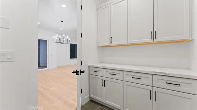 a kitchen with white cabinets and a sink