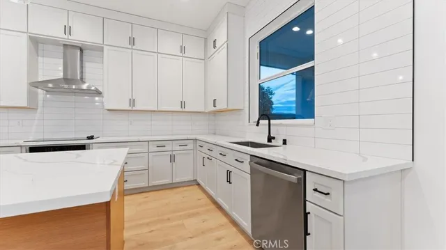 a kitchen with a sink cabinets and window