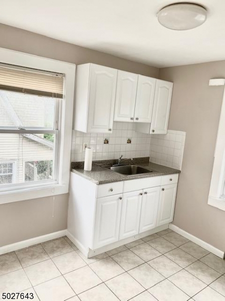 927 South Park Terrace, Unit 2 Union, NJ 07083 - Photo 10 of 12 a kitchen with granite countertop white cabinets and window