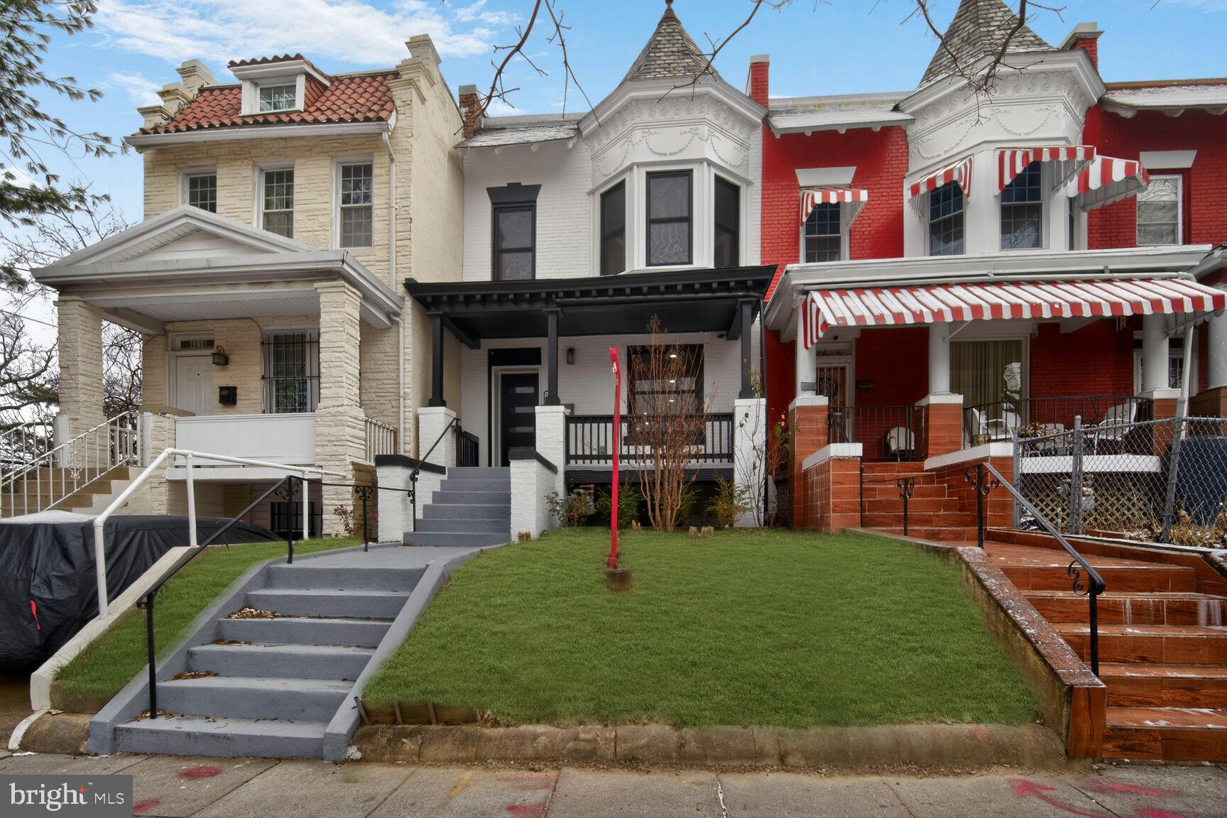 a front view of a residential apartment building with a yard