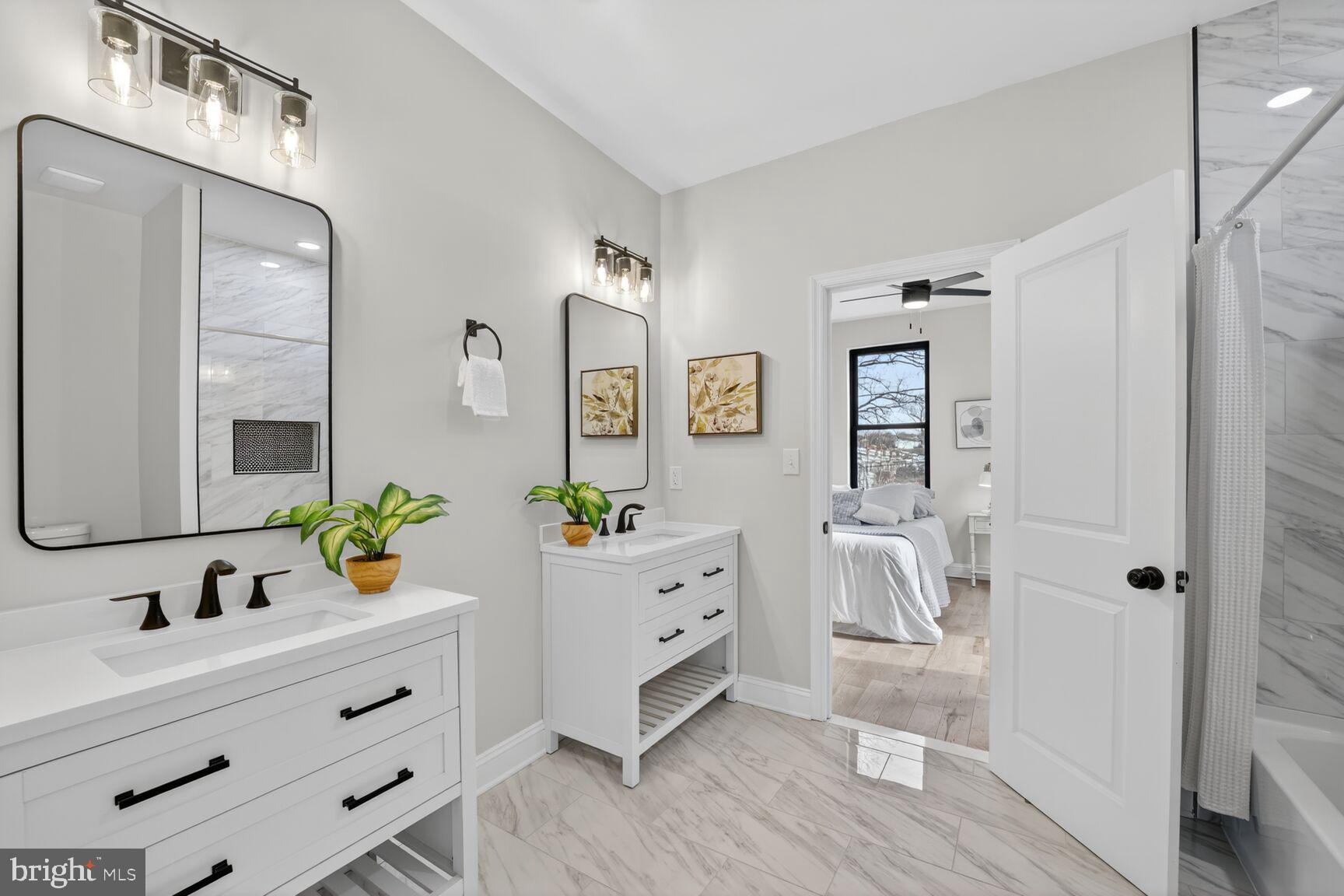 4017 14th Street Northwest Washington, DC 20011 - Photo 14 of 25 a spacious bathroom with a granite countertop sink mirror and bathtub