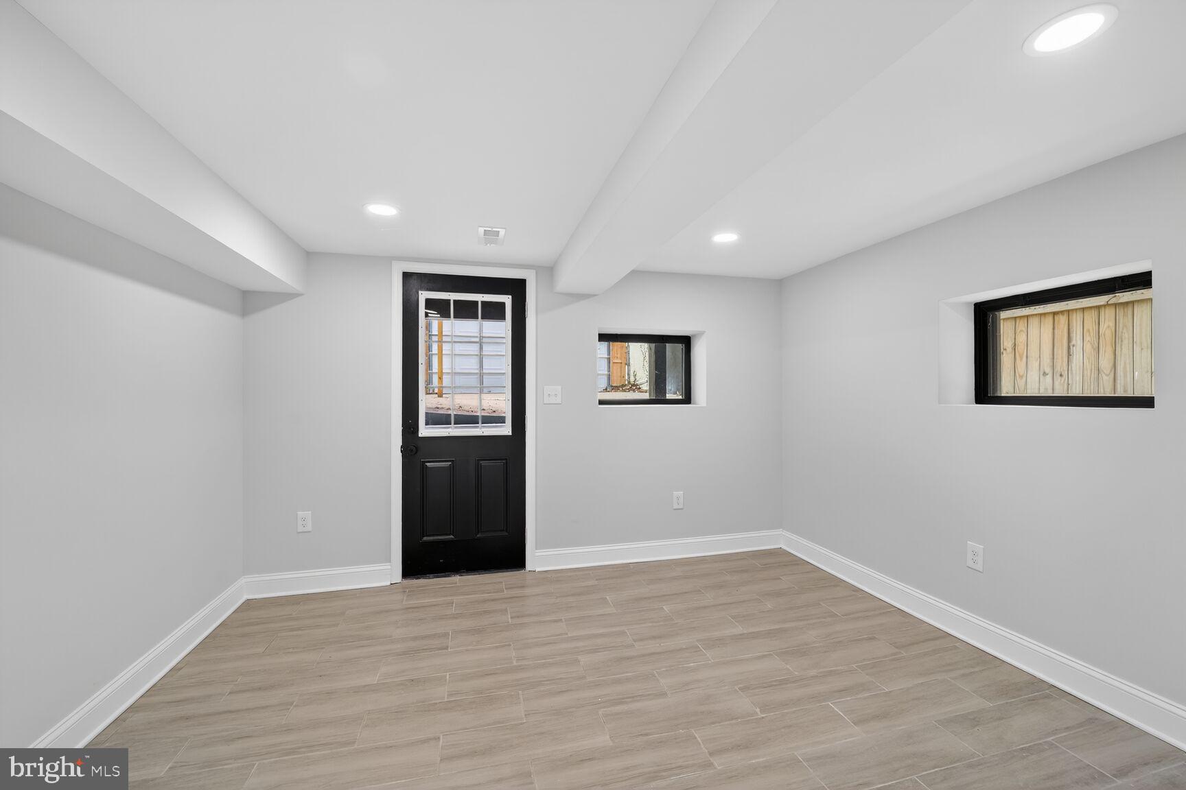 4017 14th Street Northwest Washington, DC 20011 - Photo 18 of 25 a view of an empty room with wooden floor and windows