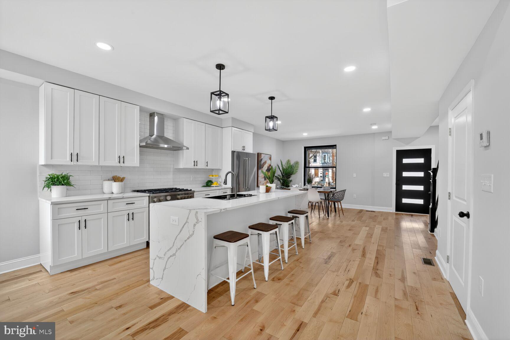4017 14th Street Northwest Washington, DC 20011 - Photo 4 of 25 a large kitchen with cabinets chairs and wooden floor