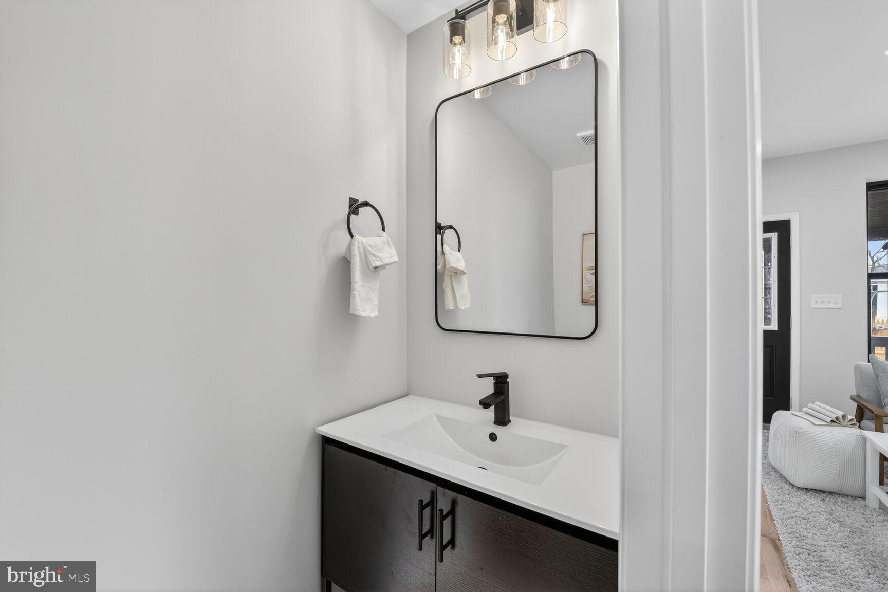 4017 14th Street Northwest Washington, DC 20011 - Photo 8 of 25 a bathroom with a sink and a mirror