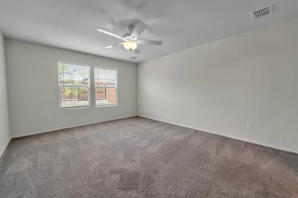 a view of an empty room with windows