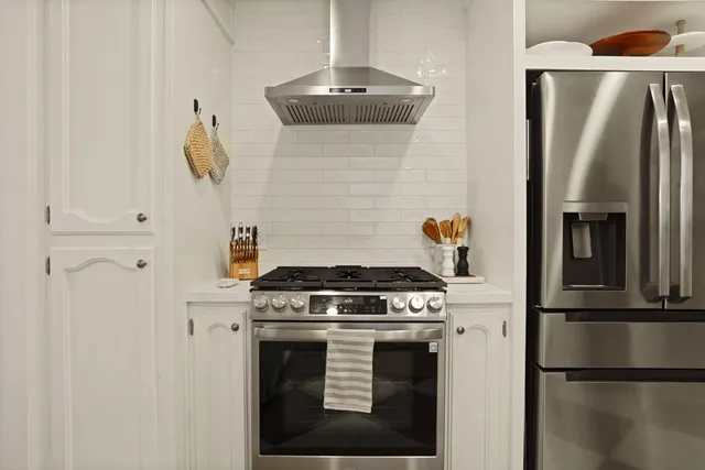 a kitchen with a stove and a refrigerator