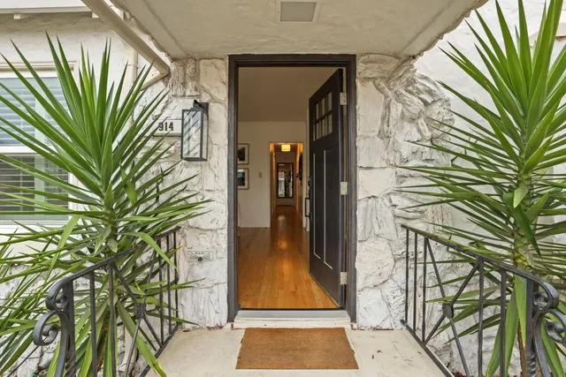 a view of a hallway with a white door and door
