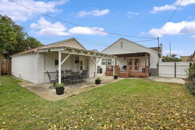 a view of a house with backyard porch and sitting area