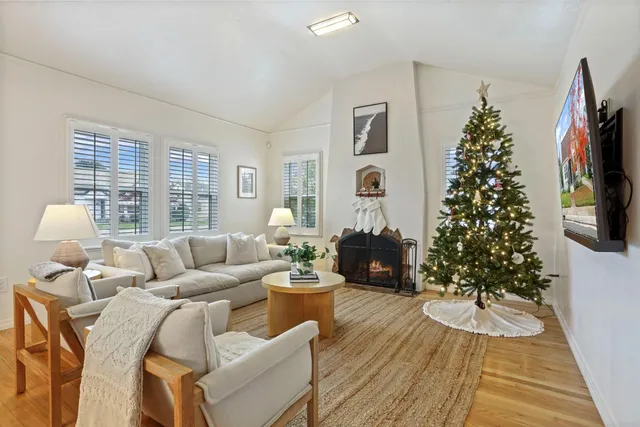a living room with furniture a window and a flat screen tv