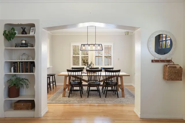 a view of a dining room with furniture window and wooden floor