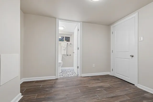 a bathroom with a toilet sink vanity and mirror