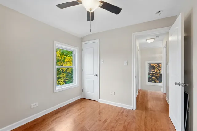 a living room with furniture and a ceiling fan