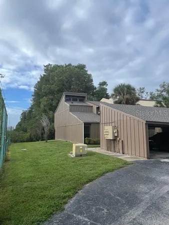 a view of a house with backyard and porch