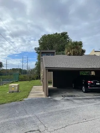 a car parked in front of a house with a small yard