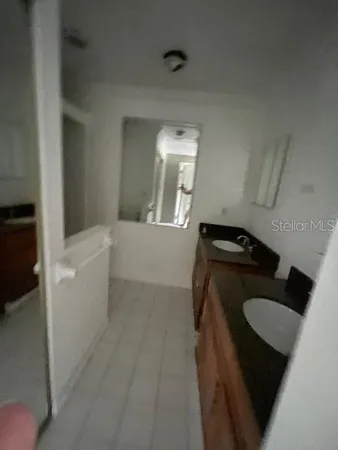 a bedroom with a bed and a mirror