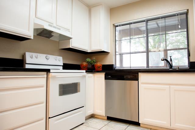 417 Kenbrook Circle San Jose, CA 95111 - Photo 16 of 22 a kitchen with a stove and white cabinets