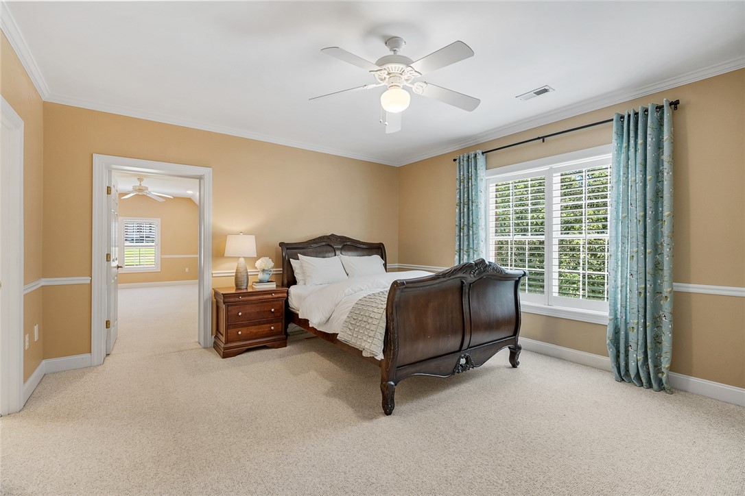 200 Graylyn Drive Anderson, SC 29621 - Photo 23 of 48 A well-lit bedroom offering plush carpeting and a serene atmosphere, perfect for rest and relaxation.