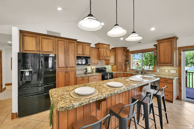 13658 South Fort Street Draper, UT 84020 - Photo 14 of 87 Kitchen featuring wood cabinetry, an extended island with a granite countertop, recessed lighting, and pendant fixtures