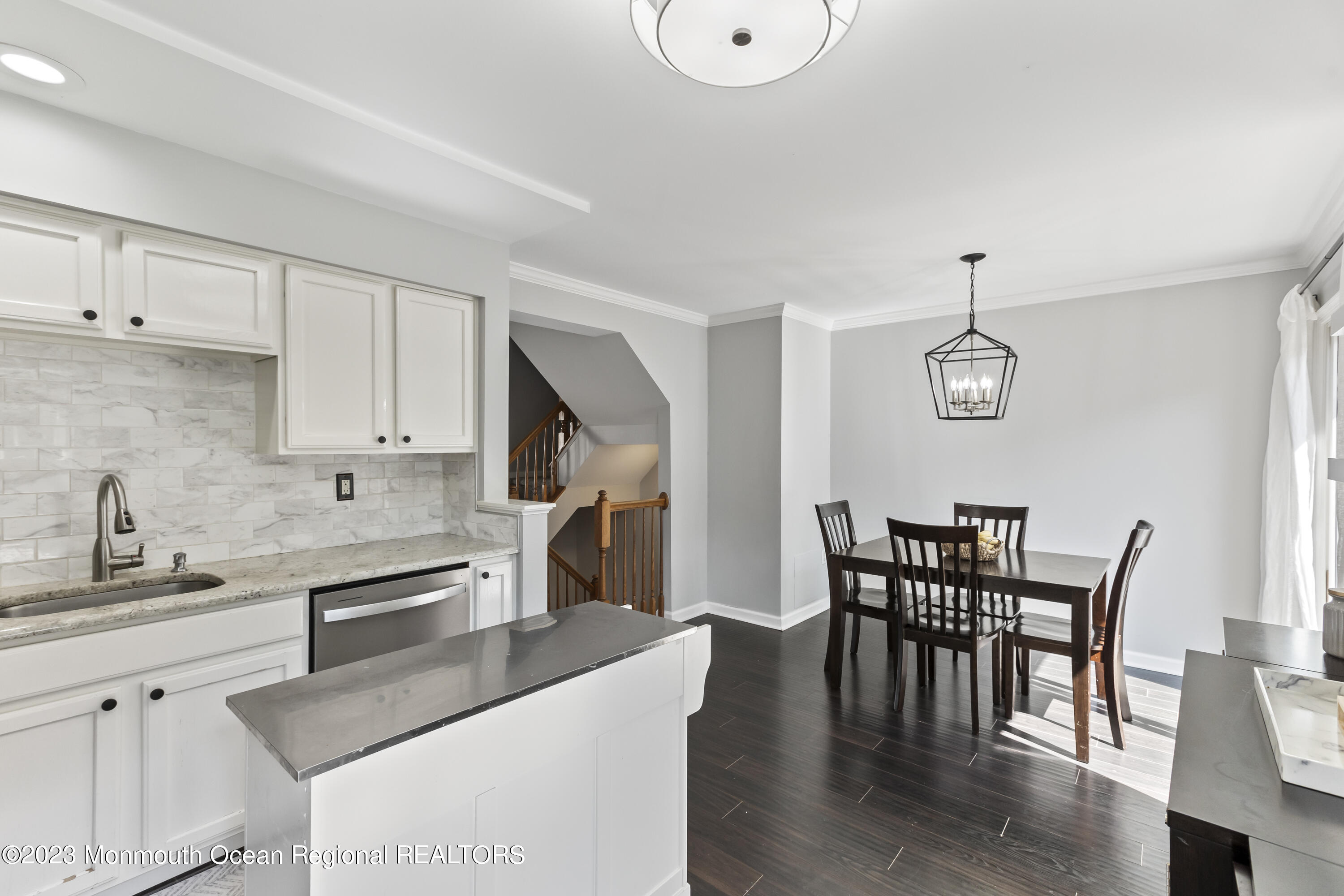 59 Saxton Road Farmingdale, NJ 07727 - Photo 17 of 30 a kitchen with stainless steel appliances granite countertop a dining table chairs and granite counter tops