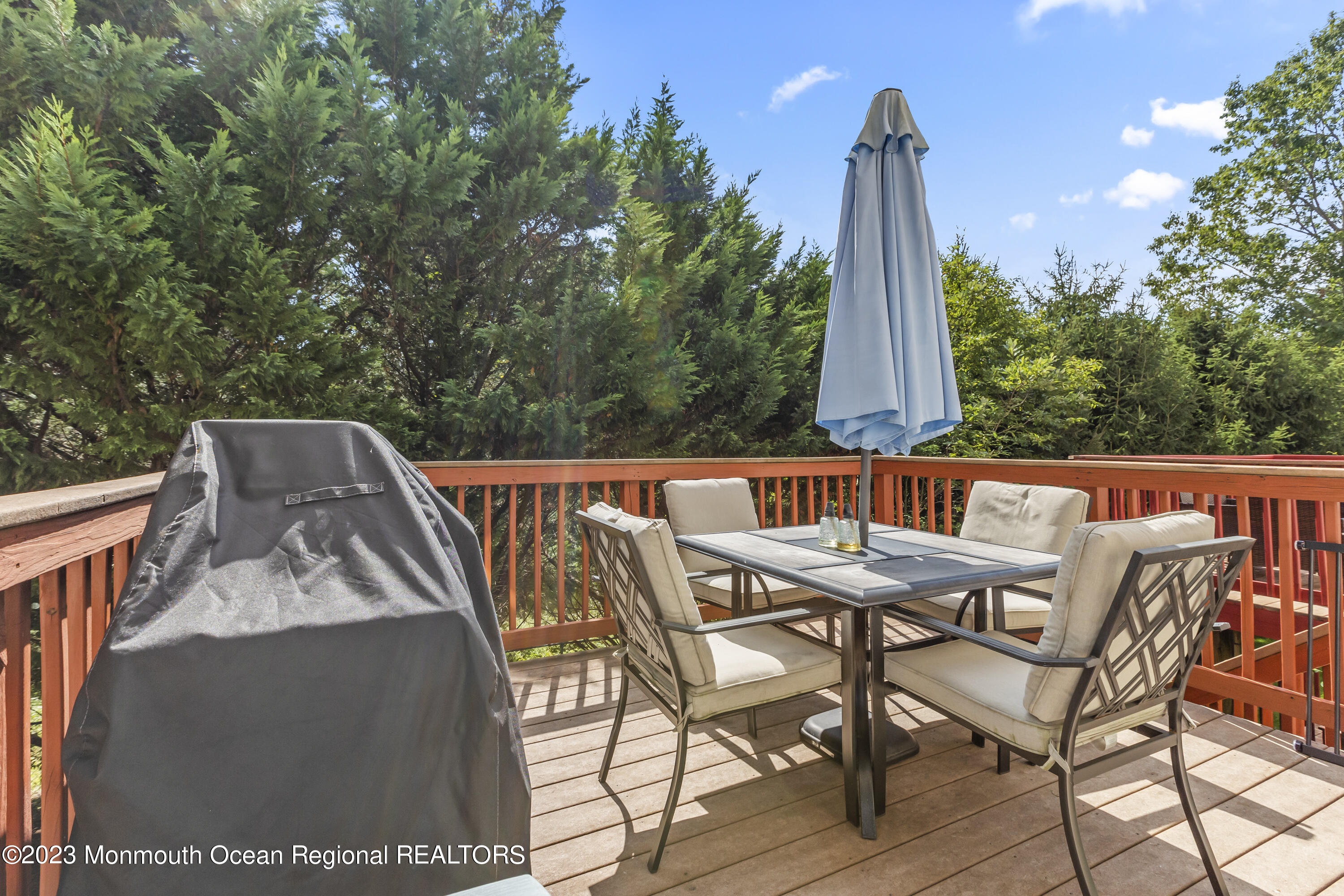 59 Saxton Road Farmingdale, NJ 07727 - Photo 18 of 30 a roof deck with table and chairs and wooden floor