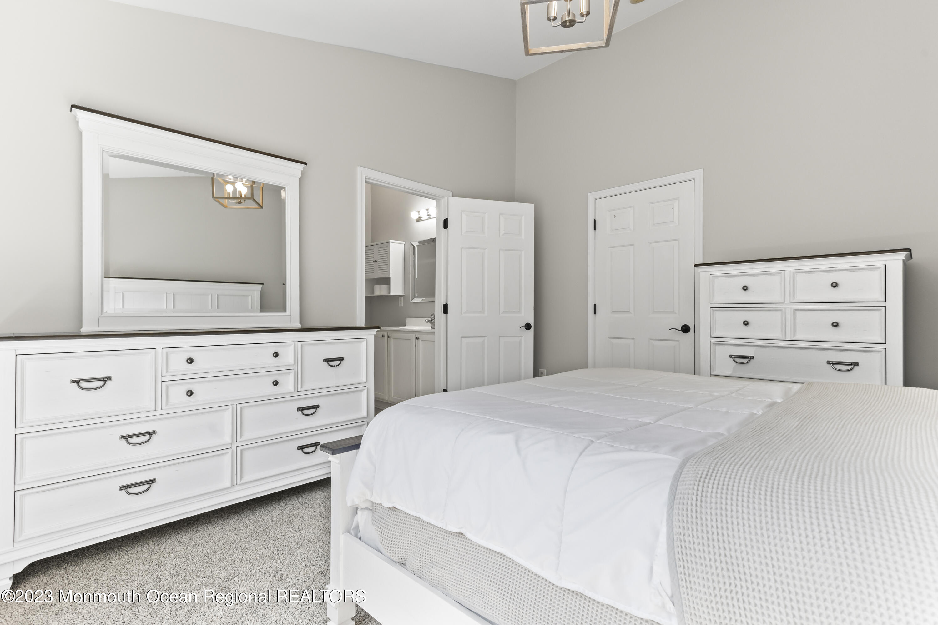59 Saxton Road Farmingdale, NJ 07727 - Photo 20 of 30 a spacious bedroom with a bed and a mirror on dresser