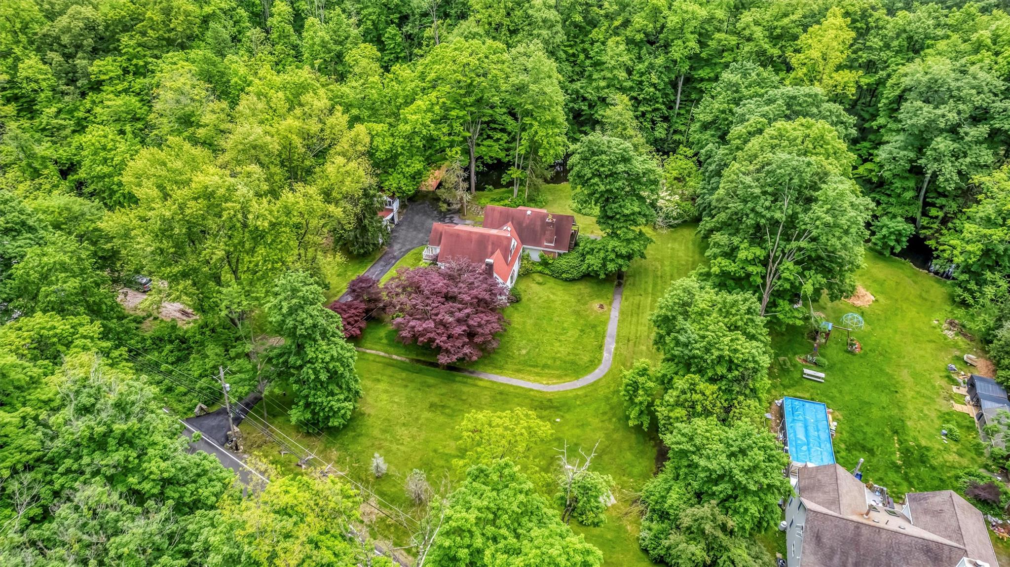 an aerial view of a house with a yard