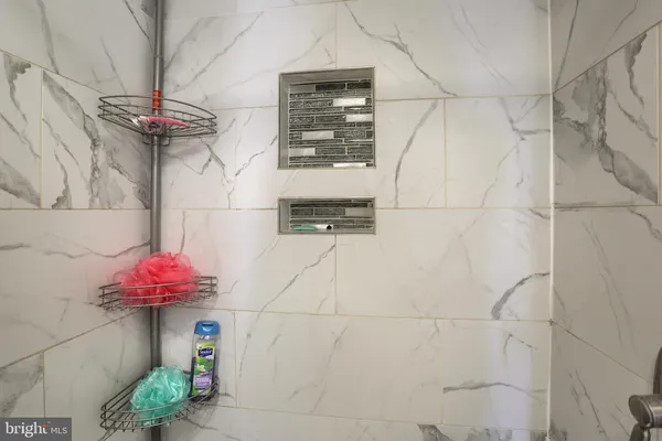 a white toilet sitting next to a shower curtain