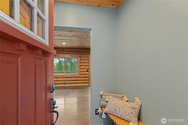 a view of a livingroom with furniture and floor to ceiling window