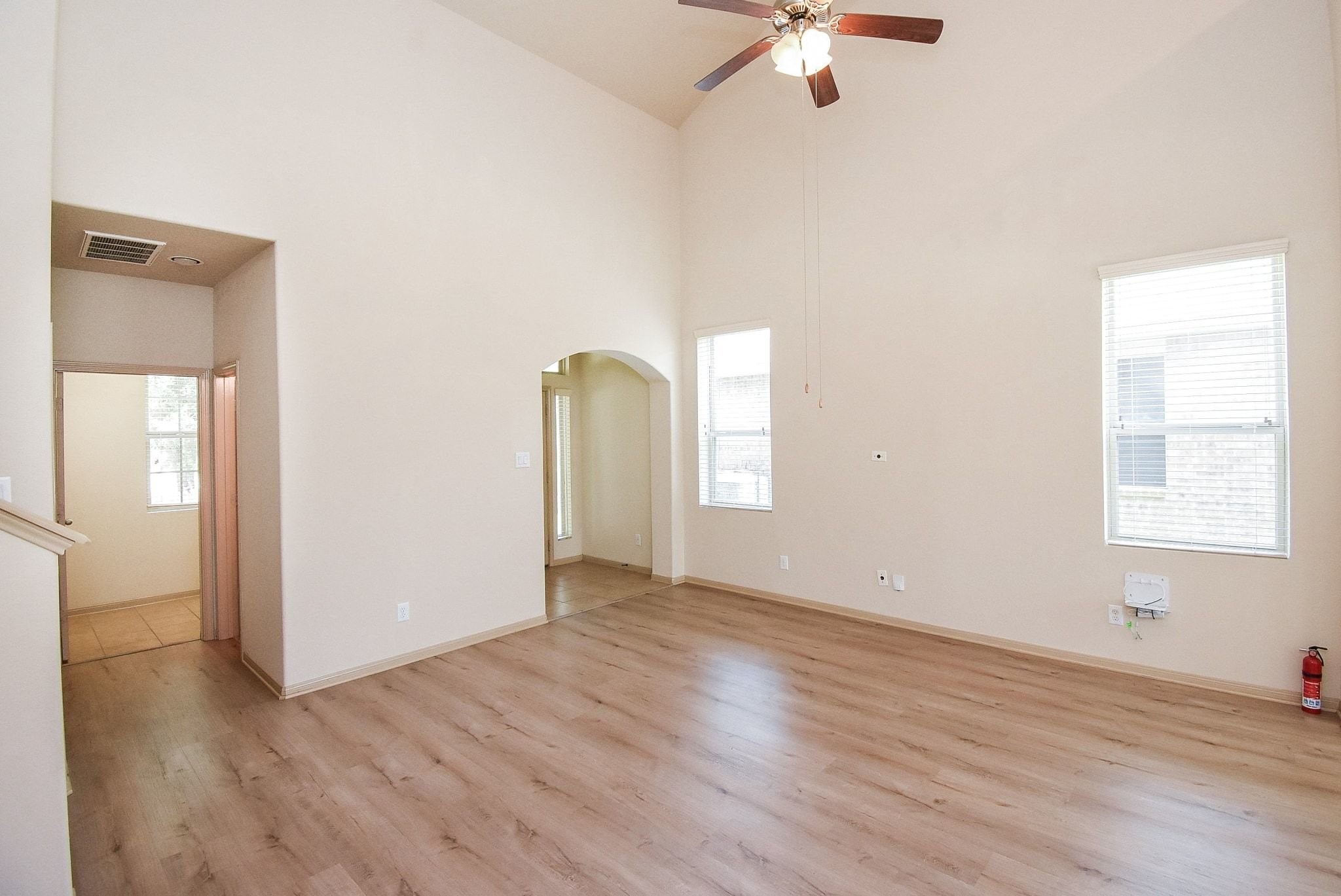 2106 Harmon Crest Court Spring, TX 77373 - Photo 8 of 37 an empty room with wooden floor cabinet and windows