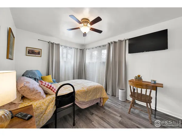 a bedroom with furniture and a ceiling fan