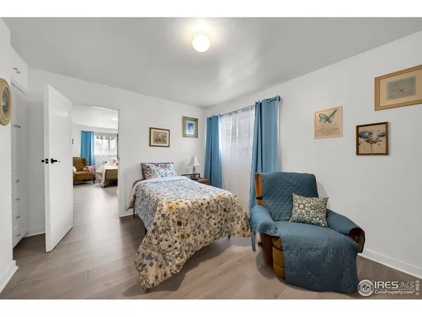 a bedroom with furniture and a wooden floor