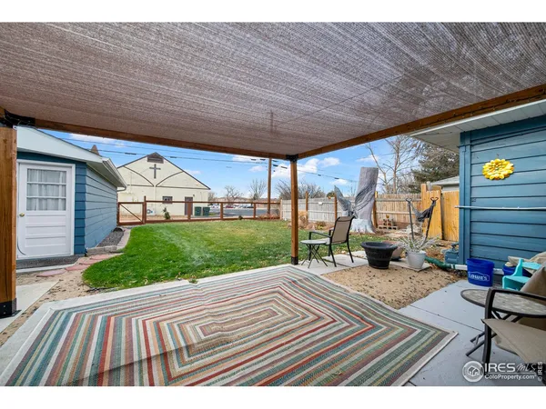 a view of a house with a yard porch and sitting area