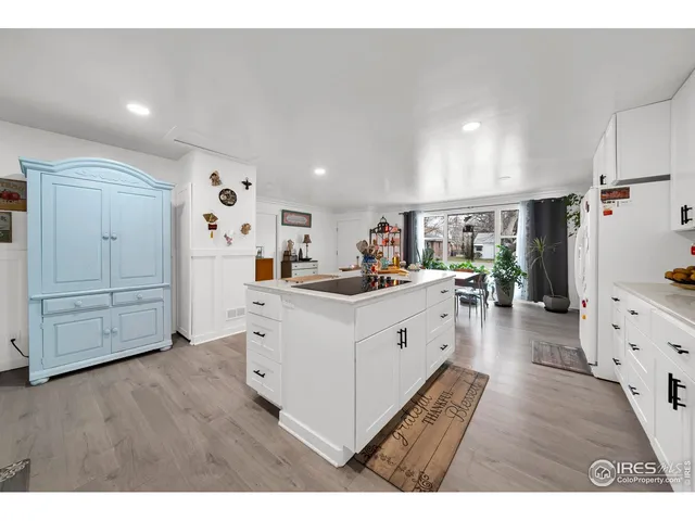 a kitchen with cabinets and wooden floor