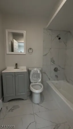 a bathroom with a toilet a sink and bathtub