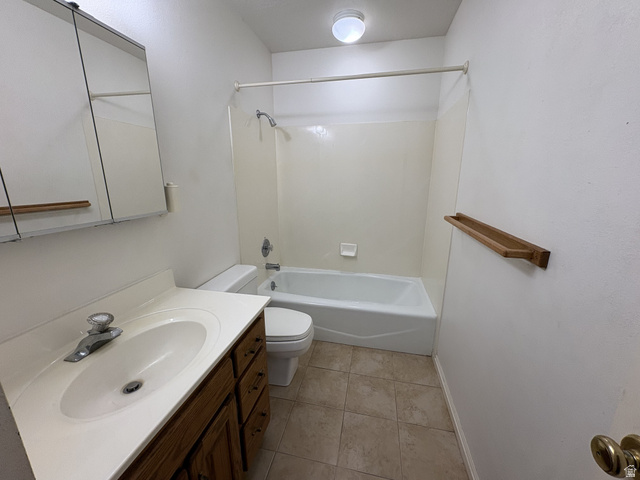 486 West 120 North Orem, UT 84057 - Photo 15 of 30 Bathroom featuring a wood-finish vanity with an integrated sink, a medicine cabinet with mirrored doors, a full-size bathtub with shower, and ceramic tile flooring