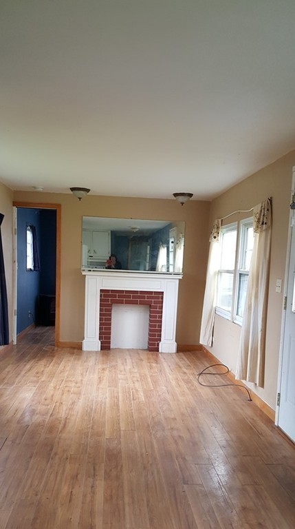 78 Better Way Springfield, MA 01119 - Photo 4 of 10 a view of an empty room with a window and fireplace