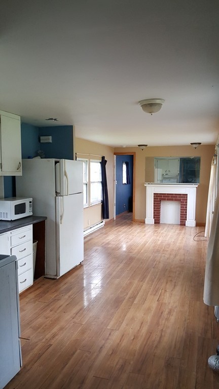 78 Better Way Springfield, MA 01119 - Photo 6 of 10 a view of empty room with kitchen and fireplace