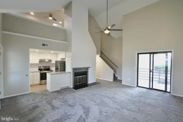 a view of a kitchen with furniture and a ceiling fan